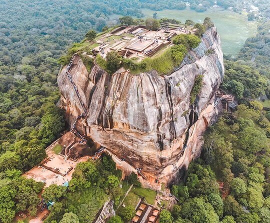 Aerial view of ancient Sigiriya Rock Fortress rising above Sri Lanka’s lush tropical forest.