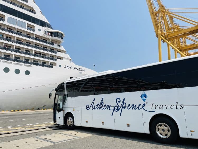 Arlene Spence tour coach parked beside MSC Preziosa cruise ship at port.