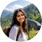 Smiling woman beside a blue train in a scenic mountain landscape.
