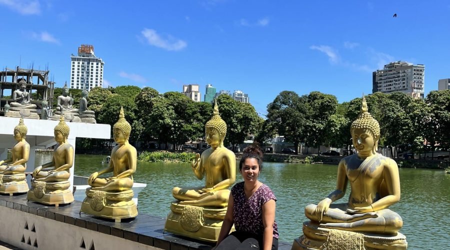 Golden Buddha statues along Beira Lake promenade in Colombo, Sri Lanka.