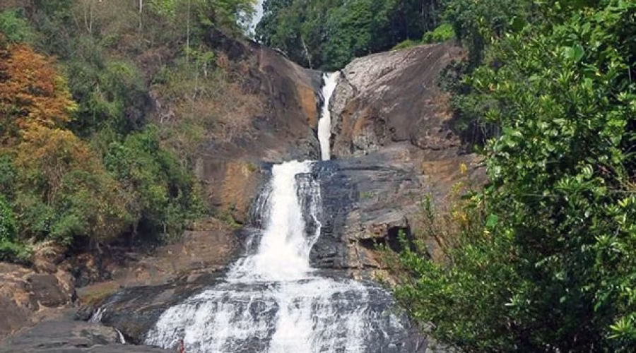 Scenic Bopath Ella Waterfall cascading through lush tropical forest in Sri Lanka.