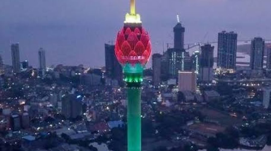 Colombo Lotus Tower glowing green and pink above the city skyline at dusk.
