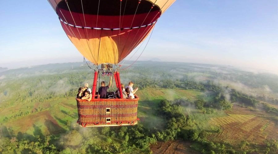 Colorful hot air balloon flying over Sigiriya’s rural landscape in Sri Lanka.