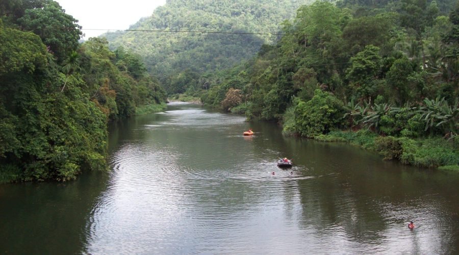 Kelani Ganga River winding through lush tropical forest and misty hills in Sri Lanka