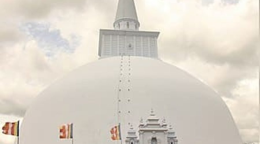 Front view of the monumental white Ruwanwelisaya Stupa beneath cloudy skies in Sri Lanka.