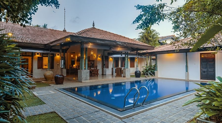 Secluded tropical villa pool and lush courtyard in Bentota, Sri Lanka.
